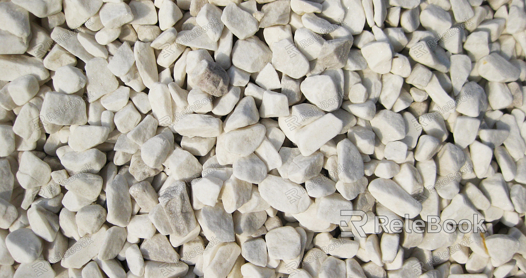 A coarse, granular material, this image showcases a textured surface of gravel, comprised of various sizes of small stones and pebbles, predominantly in shades of gray and brown.