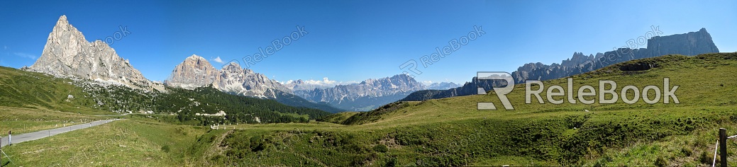 A vast, snow-covered landscape stretches to the horizon, dotted with barren trees and rocky outcrops, under a moody, overcast sky. The serene wilderness exudes a sense of tranquility and isolation.