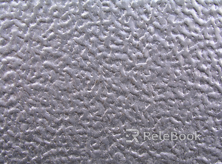 A close-up image of a textured metal surface, showcasing its intricate patterns and industrial grey tones, revealing the material's strength and durability.