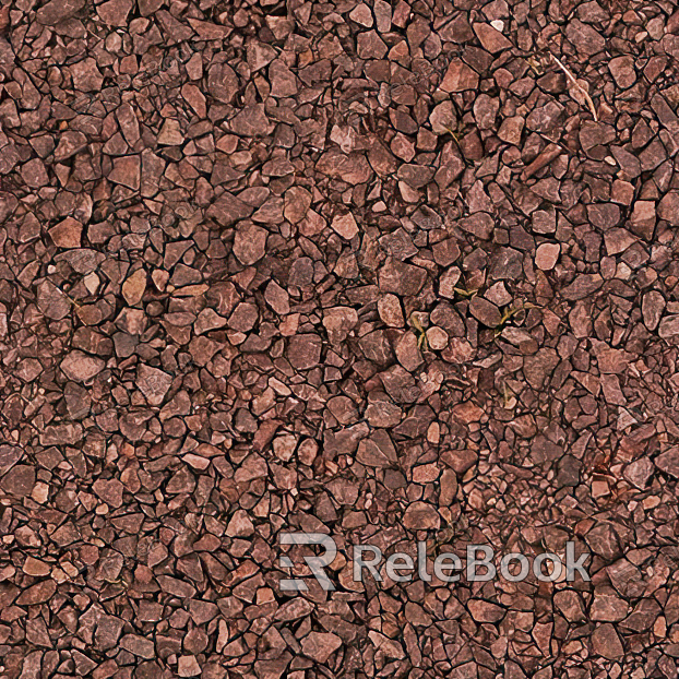 The image depicts a close-up of gravel, showcasing a mix of small, irregularly shaped stones in various shades of gray, brown, and black, set against a contrasting background.